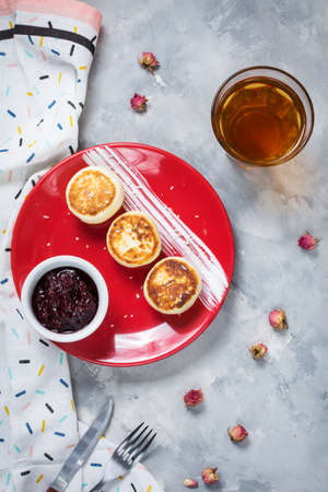 Cottage cheese pancakes on concrete background. Syrniki with jam. Homemade foodの写真素材