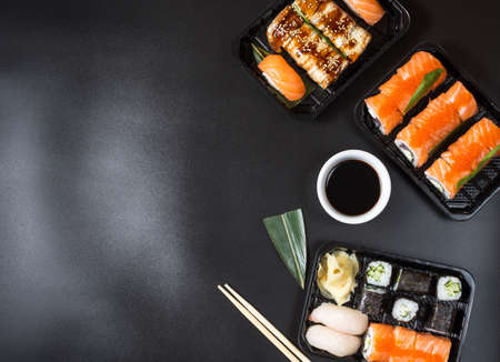 Various kinds of sushi served on black backgroundの写真素材