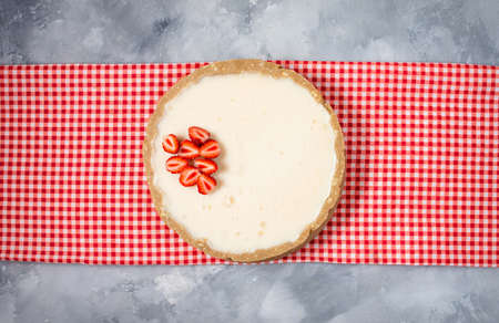Homemade cheesecake with fresh strawberries on rustic concrete background, top viewの写真素材