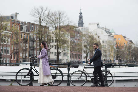 Wedding photo shooting. Bride and bridegroom walking in Amsterdam.の写真素材