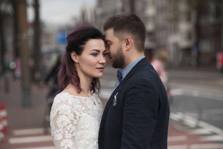 Wedding photo shooting. Bride and bridegroom walking in Amsterdam, Netherlandsの写真素材