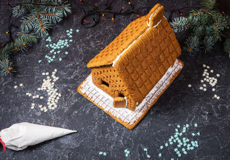 Homemade gingerbread house on black stone backgroundの写真素材