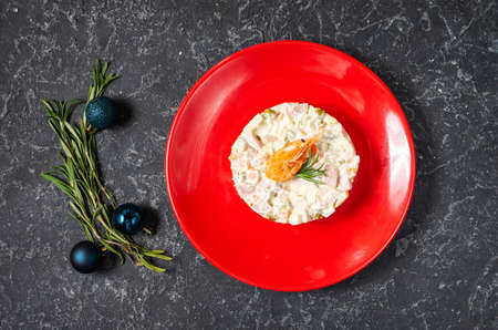 Traditional Russian Christmas Salad Olivier on black stone background. Top viewの写真素材