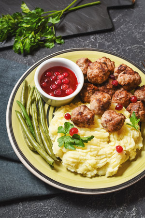 Swedish meatballs with mashed potatoes and green beans on black stone backgroundの写真素材