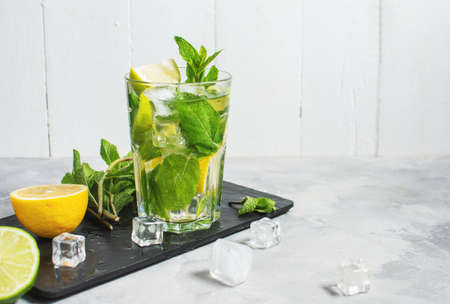 Refreshing summer alcoholic cocktail mojito with ice, fresh mint and lime. copy spaceの写真素材