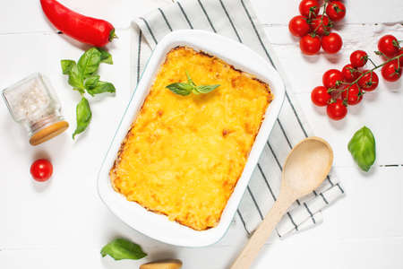 Delicious homemade italian Lasagna with bachamel sauce in the oven in a ceramic dish. rustic style, top viewの写真素材