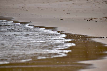 water rolling on a beach. Focus on the background.の写真素材