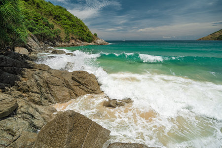 Rocky shore washed by a large sea turquoise wave. Summer vacation and nature travel adventure conceptの写真素材