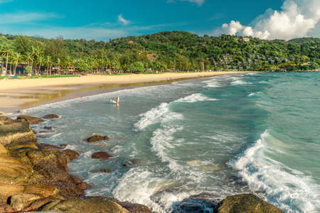 Tropical beach with ocean long waves and coconut palm at sunset lights. Surf conceptの写真素材