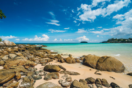 Beautiful and wild lonely beach with rough granite rocks, white sand, palm trees in a jungle and turquoise water of the indian ocean. Summer vacation and nature travel adventure concept.. Summer composition. High quality photoの写真素材