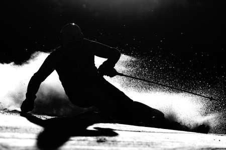 Silhouette of a man who skis during the competitionの写真素材