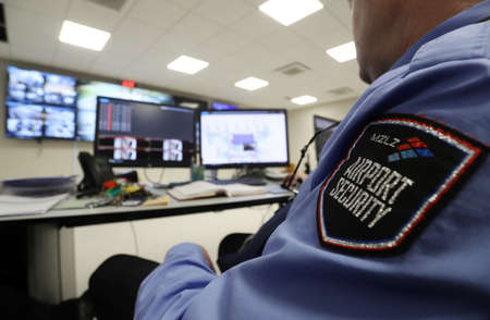 Security officer sitting in control room on the new terminal of Franjo Tudjman airport in Zagreb,...
