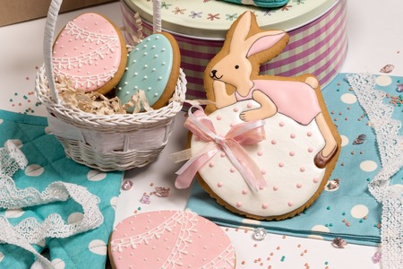 sweet easter eggs in busket and rabbit honey-cake, pink blue color background, beautiful design...