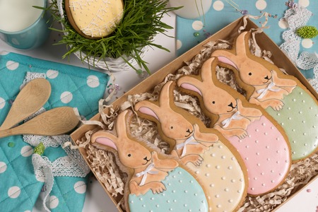 family holiday present box with nice sweet multicolored  trendy easter rabbits honey-cake on kithen...