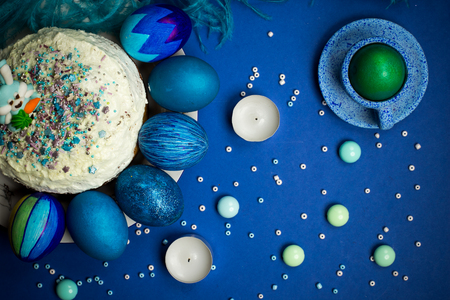 Bright Blue painted eggs, easter sweet cake with sugar figure of hare, decorated with sweet sprikling, gingerbread coocies, celebration  kitchen table, food photographyの写真素材