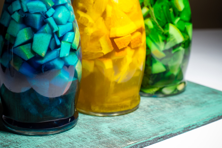 three bottles with bright color fruit lemonade, blue green yellow special paited bar drinksの写真素材