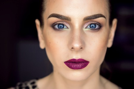 Beautiful girl with perfect skin and wine lips. Picture taken in the studio. Blue eyes and graphic eyebrows.の写真素材