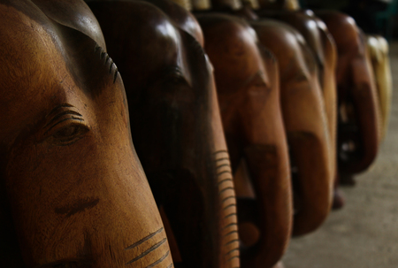 Souvenir wooden statues of elephants in the journeyの写真素材