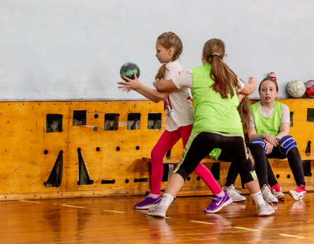 Russia, Vladivostok, 02/26/2019. Kids play handball indoor. Sports and physical activity. Training and sports for children.のeditorial素材