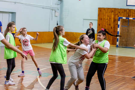 Russia, Vladivostok, 02/26/2019. Kids play handball indoor. Sports and physical activity. Training and sports for children.のeditorial素材