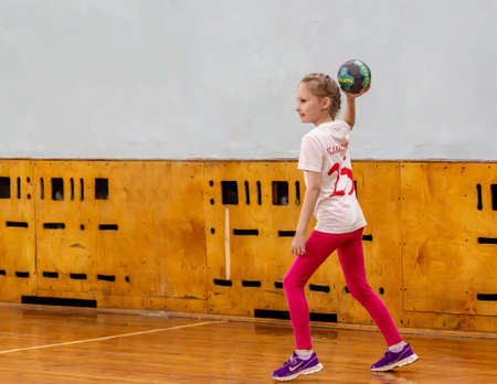 Russia, Vladivostok, 02/26/2019. Kids play handball indoor. Sports and physical activity. Training and sports for children.のeditorial素材
