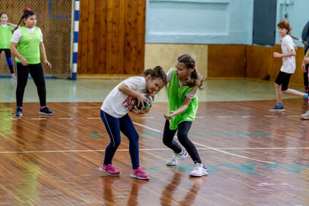 Russia, Vladivostok, 02/26/2019. Kids play handball indoor. Sports and physical activity. Training and sports for children.のeditorial素材