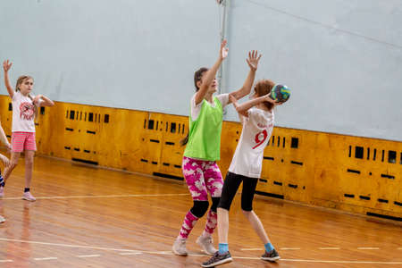 Russia, Vladivostok, 02/26/2019. Kids play handball indoor. Sports and physical activity. Training and sports for children.のeditorial素材