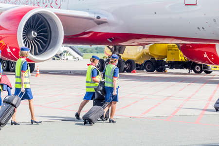 Russia, Vladivostok, 08/17/2020. Crew of airplane in official uniform of Rossiya Airlines goes to...
