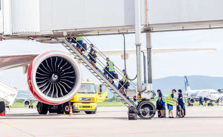 Russia, Vladivostok, 08/17/2020. Crew of airplane in official uniform and medical masks boarding to plane. Crew of plane. Aviation and transportation. Plane crew protection against COVID-19.のeditorial素材