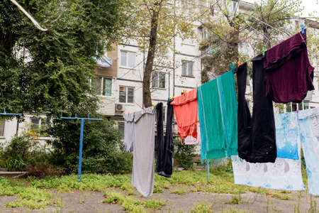 Laundry dries on the rope in the courtyard of Khrushchyovka. Khrushchyovka is a common type of old low-cost apartment building in Russia and post-Soviet space. house hold concept. Russia, Vladivostok.の写真素材