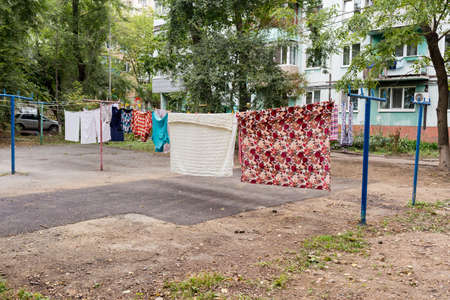 Laundry dries on the rope in the courtyard of Khrushchyovka. Khrushchyovka is a common type of old low-cost apartment building in Russia and post-Soviet space. house hold concept. Russia, Vladivostok.の写真素材