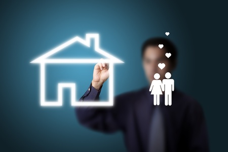 business man drawing house and couple of loversの写真素材