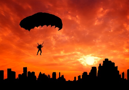 parachute man at sunset silhouetted