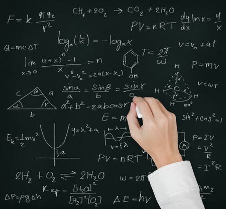 teacher hand writing various high school maths and science formula on blackboardの写真素材