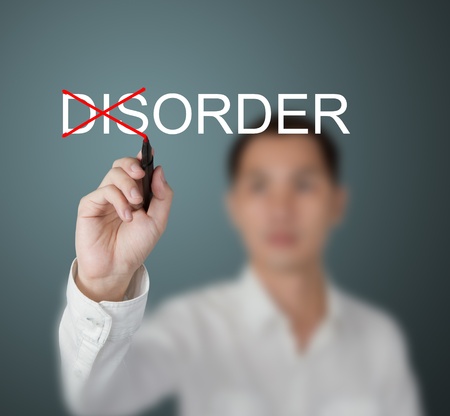 business man change disorder to order by write red cross markの写真素材