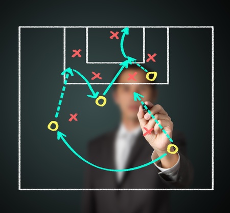 soccer coach writing strategy of attacking gameの写真素材