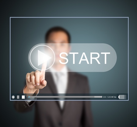 business man pressing start button to play video clip