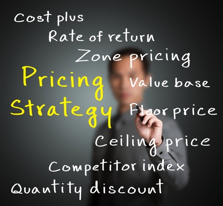 business man writing pricing strategy of marketing conceptの写真素材