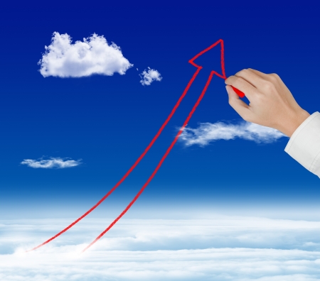 business hand drawing rising arrow graph over skyの写真素材