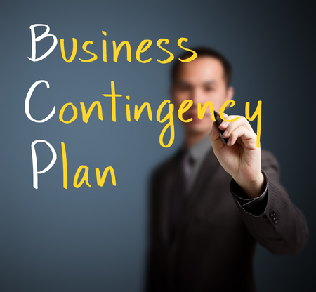 business man writing business contingency planの写真素材