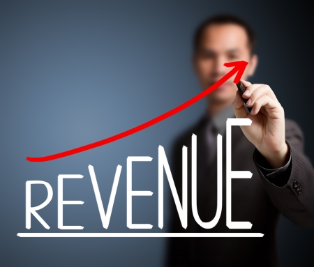 business man writing revenue growth graphの写真素材