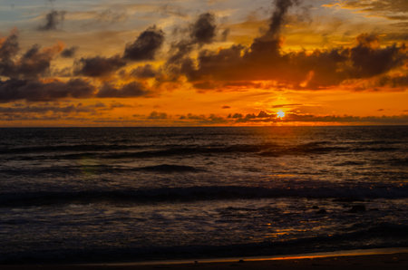 Cloudy sunset on the beach at Tanneeru Bhavi,  Mangalore, Indiaの写真素材