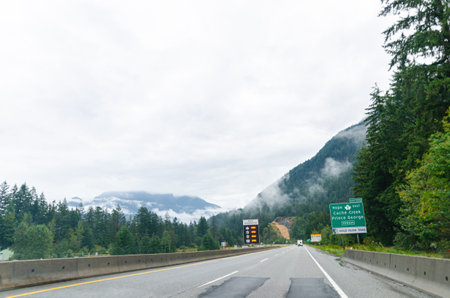 Highway in Hope  BC, Canada with cloud covered mountains in the backgroundの写真素材