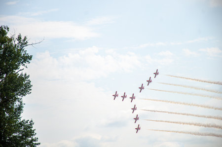 A formation of nine aircraft performing display and aerobatics during an airshow in Abbotsford, BC, Canadaの写真素材