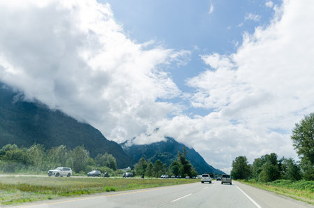 Highway in Hope  BC, Canada with cloud covered mountains in the backgroundの写真素材