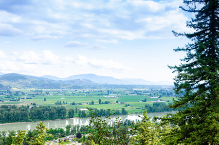 View of the Mission town with Fraser River, lush green valley and the mountains in the background - Fraser Valley, British Columbia, Canadaの写真素材