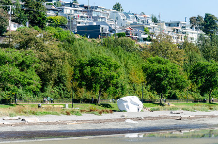 View of White Rock from the  White Rock Pier in Surrey, BC, Canada. White Rock towns houses seen on the hill slope in the background and the low tide semiahmoo bay in the foreground.の写真素材