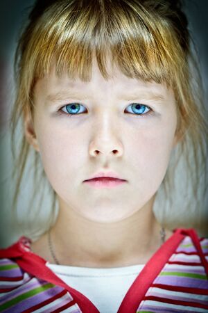 Facial portrait of a caucasian girl with blue eyes and straw-colored hair の写真素材
