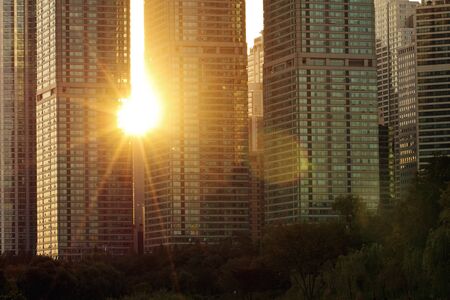 The rays of sun on sunset shining through the gap between buildingsの写真素材