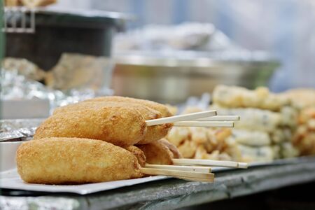 Korean street food: hot dogs wrapped in French fries gamja dogs with selected focus